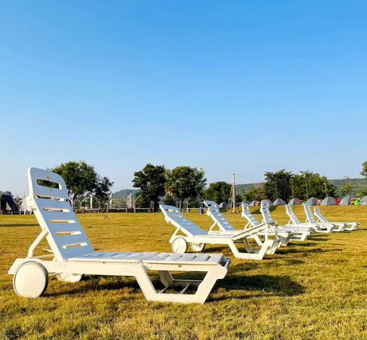 Loungers on the lawn at Harivillu Resort
